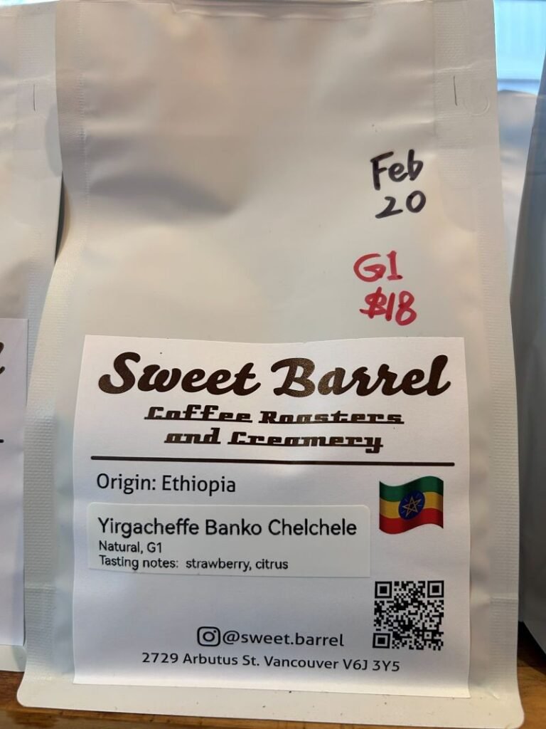 White coffee bag using separate printed labels for coffee identity, origin, tasting notes and a QR code.