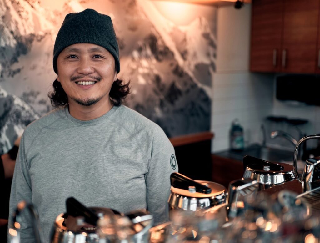 JW working behind the coffee bar at a local café in Whistler, British Columbia.